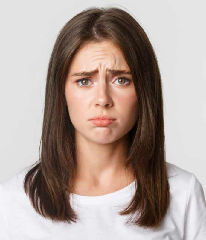 Close-up of upset and gloomy cute brunette girl sulking, looking miserable